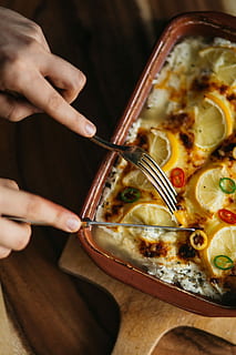 fish casserole, lemon, herbs, Fish, casserole, cheese, food, homemade, lunch, meal, dinner, dish, leomn, pizza, gourmet, vegetable, cooked, table, food And Drink, women, rustic, restaurant, wood - Material, freshness, indoors, tomato, close-up, savory Sauce, ready-To-Eat, people, cultures, heat - Temperature, italian Culture, human hand, human body part, preparation, one person, hand, real people, holding, lifestyles, high angle view, unrecognizable person, focus on foreground, body part, italian food, finger, temptation, 5K