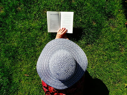 person, wearing, gray, sun hat, holding, book, hat, read, summer, relax, books, grass, garden, are, outdoors, nature, one person, real people, plant, green color, high angle view, lifestyles, day, leisure activity, human body part, land, hand, human hand, field, unrecognizable person, growth, 2K, CC0, public domain, royalty free