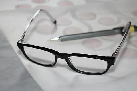 black, framed, eyeglasses, gray, pen, white, printer paper, glasses, reading glasses, study, learn, student, school, reading aid, drawing, artist, business, indoors, healthcare and medicine, still life, no people, close-up, studio shot, table, single object, focus on foreground, high angle view, paper, personal accessory, eyewear, simplicity, scissors, eyesight, group of objects, 4K, CC0, public domain, royalty free