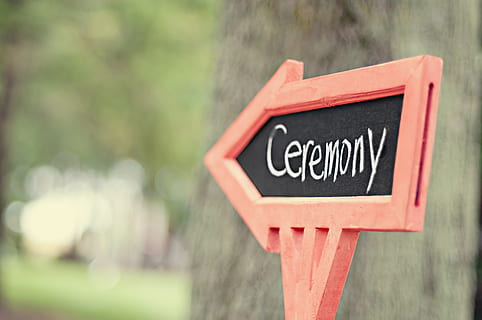 wood, sign, arrow, direction, blur, ceremony, chalk, chalk board, chalkboard, daylight, outdoors, signage, tree, wedding, wooden, communication, text, western script, focus on foreground, capital letter, close-up, no people, day, road sign, red, road, information, guidance, information sign, non-western script, message, warning sign, script, 4K, CC0, public domain, royalty free