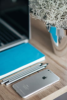 silver iphone, blue, notebook, pencils, Silver, iPhone, Apple, mobile, smartphone, notepad, laptop, computer, technology, equipment, no People, business, pC, indoors, close-up, day, wireless technology, table, portable information device, communication, focus on foreground, smart phone, mobile phone, connection, still life, selective focus, high angle view, portability, computer equipment, keyboard, turquoise colored, 2K