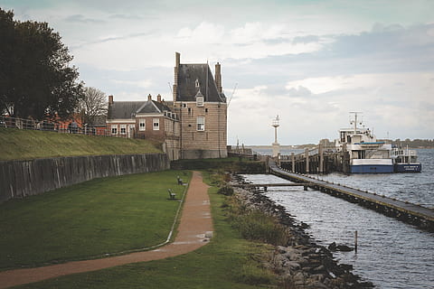 green, grass, path, trees, plants, nature, sea, ocean, water, bridge, coast, house, building, architecture, built structure, building exterior, sky, cloud - sky, transportation, city, river, day, plant, no people, travel destinations, outdoors, travel, 5K, CC0, public domain, royalty free