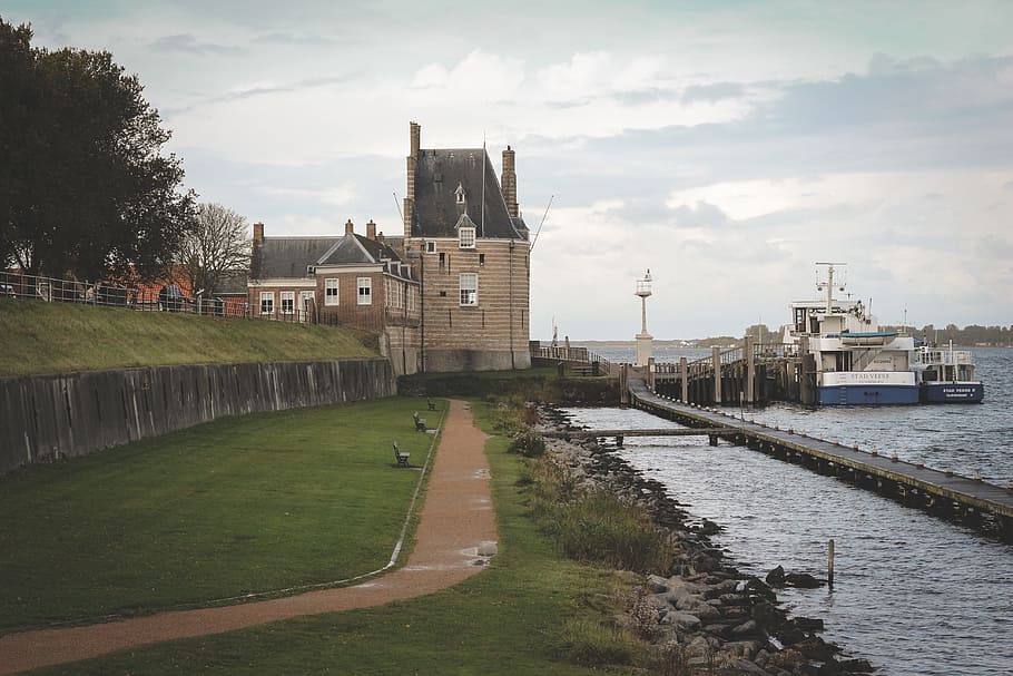 green, grass, path, trees, plants, nature, sea, ocean, water, bridge, coast, house, building, architecture, built structure, building exterior, sky, cloud - sky, transportation, city, river, day, plant, no people, travel destinations, outdoors, travel, 5K