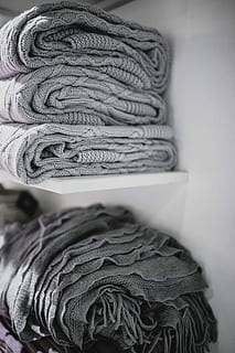 sweaters, fabrics, stacked, shelves, Folded, blanket, stack, fabric, material, shelf, rug, woolen, sweater, wool, woven, clothing, textile, fashion, close-up, indoors, knitting, still life, no people, pattern, selective focus, art and craft, focus on foreground, warm clothing, ball of wool, softness, thread, variation, scarf, 4K