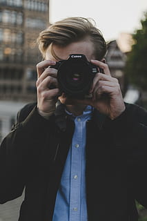 man, using, canon dslr camera, people, guy, millennials, camera, lens, photographer, camera - Photographic Equipment, photography Themes, men, one Person, caucasian Ethnicity, outdoors, adult, holding, photographing, hobbies, technology, front view, photographic equipment, real people, lifestyles, activity, occupation, portrait, leisure activity, focus on foreground, standing, digital camera, slr camera, obscured face, digital single-lens reflex camera, modern, 5K