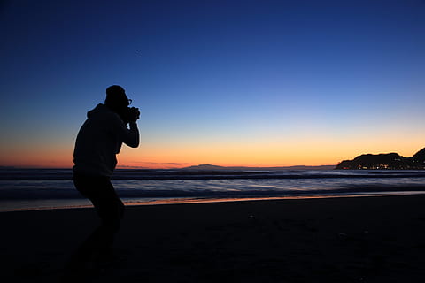 silhouette, person, standing, seashore, photographer, click, snap, compose, shoot, camera, beach, outdoors, nature, earth, ocean, beach front, sea, photography, photo, portrait, young, woman, digital, girl, lens, vintage, picture, female, retro, capture, hobby, casual, white, adult, professional, equipment, people, shot, snapshot, fashion, technology, studio, taking, trendy, happy, sky, land, water, sunset, real people, beauty in nature, scenics - nature, lifestyles, leisure activity, men, tranquil scene, one person, tranquility, horizon over water, idyllic, 5K, CC0, public domain, royalty free