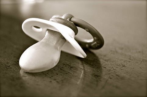 closeup, photo, greyscale pacifier, brown, wooden, table, dummy, pacifier, baby, silicone, plastic, old, at that time, sucking, born, child, forget, lost, black, white, wood - material, no people, selective focus, close-up, indoors, simplicity, still life, single object, human representation, food and drink, art and craft, two objects, shape, celebration, representation, day, creativity, food, 4K, CC0, public domain, royalty free