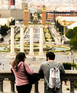 architecture, backpack, balustrade, blur, buildings, city, couple, high angle shot, man, partner, people, pillars, standing, woman, rear view, built structure, real people, building exterior, two people, lifestyles, togetherness, bonding, three quarter length, adult, water, leisure activity, women, day, casual clothing, men, couple - relationship, outdoors, looking at view, arm around, 4K