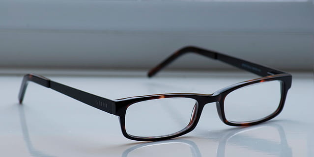 eyeglasses, tortoiseshell frame, glasses, spectacles, black, frames, white, background, eyes, vision, sight, protective, covering, plain, reflections, reflective, surface, eyesight, close-up, no people, indoors, single object, glass - material, security, still life, nature, focus on foreground, transparent, protection, safety, wood - material, shadow, fashion, eyewear, absence, personal accessory, 4K, CC0, public domain, royalty free
