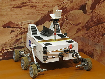 white, robot, brown, table, mars rover, exhibit, space, exploration, research, saint louis, science center, missouri, usa, vehicle, technology, system, desert, no people, transportation, machinery, industry, manufacturing equipment, day, outdoors, rock, rock - object, high angle view, travel, environment, indoors, mountain, solid, land, mode of transportation, representation, land vehicle, climate, arid climate, 1080P, CC0, public domain, royalty free