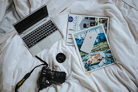 silver laptop, camera, magazines, items, white, bed sheets, Silver, laptop, bed, sheet, technology, computer, bedroom, wireless Technology, internet, high angle view, no people, indoors, industry, day, directly above, still life, communication, furniture, textile, large group of objects, connection, table, wood - material, abundance, 4K, CC0, public domain, royalty free