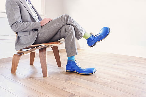 person, sitting, wearing, gray, formal, suit, pair, blue, leather shoes, leather, shoes, people, whimsical, lazy, clown, business, chair, meeting, silly, funny, contrast, sunlight, bright, modern, fashion, men, indoors, adult, flooring, one Person, males, caucasian Ethnicity, shoe, home Interior, lifestyles, copy Space, adults Only, full length, human leg, low section, one man only, side view, relaxation, seat, wood, body part, hardwood floor, human body part, women, jeans, human limb, contemplation, hairstyle, 5K