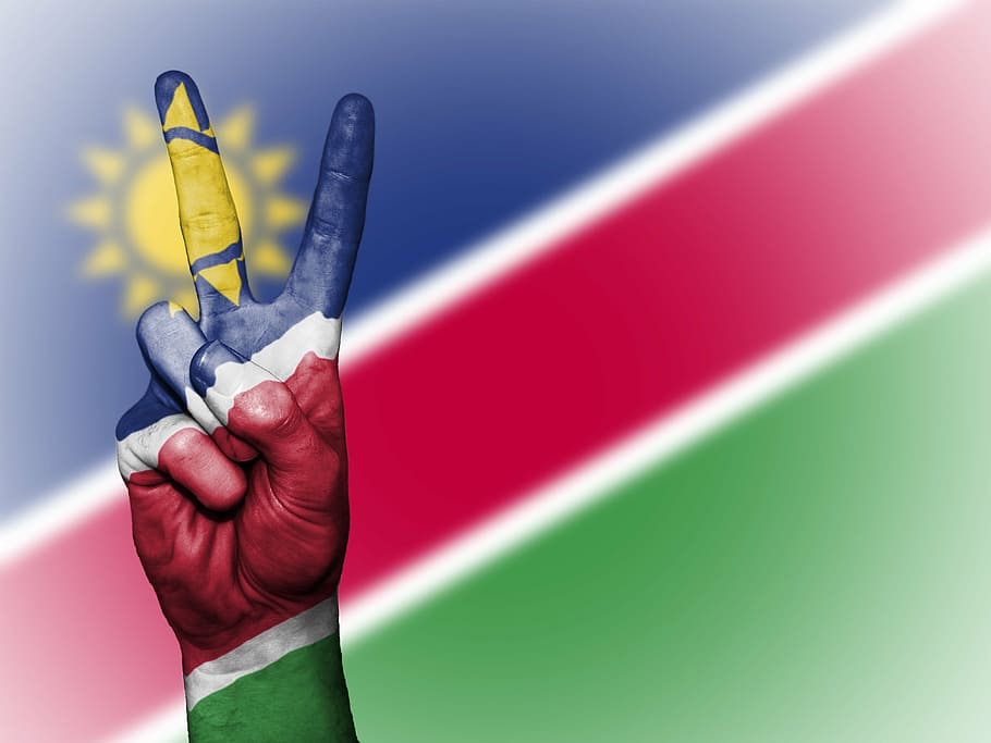 namibia, pau, mà, nació, fons, banner, colors, país, ensign, bandera, icona, nacional, estat, símbol, turisme, viatjar, mà humana, part del cos humà, primer pla, gent, una persona, adult, dia, celebració, dit humà, dit, persona irreconeixible, vermell, creativitat, part del cos, groc, persones reals, a l'interior, art i artesania, funció de construcció de parets, perspectiva personal, 4K