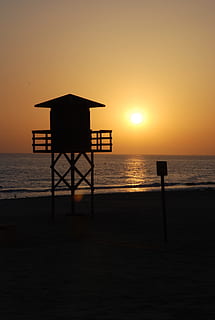 tramonto, Cadice, spiaggia, mare, cielo, acqua, orizzonte sull'acqua, orizzonte, architettura, scenics - natura, capanna, struttura costruita, bellezza nella natura, sole, silhouette, capanna del bagnino, scena tranquilla, sicurezza, struttura fatta dall'uomo, colore arancione, nessuno, all'aperto, 2K, CC0, dominio pubblico, privo di copyright