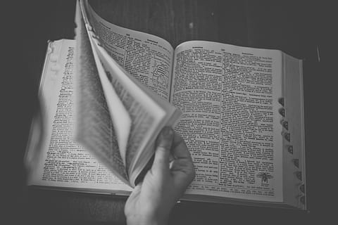 grayscale photo, person, holding, book page, dictionary, book, reading, publication, indoors, education, text, page, people, paper, human hand, belief, open, spirituality, literature, hand, religion, close-up, expertise, studying, 4K, CC0, public domain, royalty free