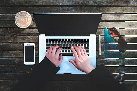 silver macbook, laptop, apple, macbook, computer, browser, research, study, school, mobile, phone, drink, student, business, typing, writing, one person, technology, communication, wireless technology, table, human hand, directly above, real people, connection, personal perspective, high angle view, using laptop, human body part, hand, keyboard, portable information device, finger, 5K, CC0, public domain, royalty free