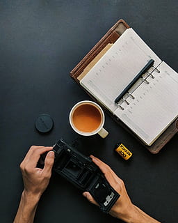 tazza, tè, fa, qualunque cosa, meglio!, piatto, posare, fotografia, taccuino, caffè, tavolo, progettista, spazio di lavoro, calendario, organizzatore, mano umana, mano, bere, pubblicazione, parte del corpo umano, detenzione, libro, tazza di caffè, caffè - bevanda, boccale, rinfresco, tecnologia, comunicazione, persone, persone reali, vista dall'alto, tecnologia wireless, dito, 2K, CC0, dominio pubblico, privo di copyright
