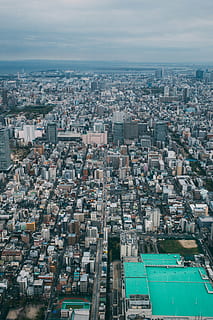 aerial, view, city, architecture, buildings, infrastructure, cloud, sky, skyscraper, tower, urban, skyline, rooftops, cityscape, urban Scene, urban Skyline, aerial View, downtown District, built Structure, building exterior, building, residential district, crowd, crowded, day, nature, outdoors, high angle view, cloud - sky, water, community, transportation, office building exterior, 5K