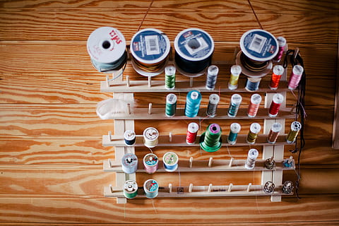 green, blue, red, thread, top, brown, wooden, surface, colorful, colourful, spools, threads, indoors, wood - material, large group of objects, variation, table, choice, still life, no people, high angle view, wood, container, directly above, collection, arrangement, in a row, side by side, order, bottle, abundance, flooring, 5K, CC0, public domain, royalty free