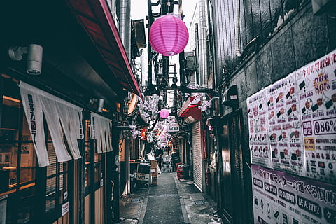 alley, architecture, business, posters, stores, street, town, built structure, building exterior, real people, city, women, men, lifestyles, building, lighting equipment, two people, people, walking, adult, day, direction, incidental people, the way forward, communication, outdoors, 5K, CC0, public domain, royalty free