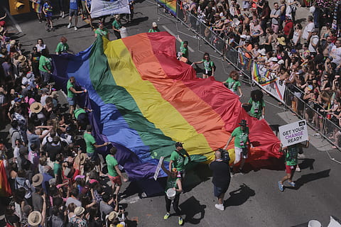 people, holding, multicolored, textile, Pride, Flag, Pride Flag, Canada, Toronto, pride, flag, july, gay, lesbian, celebration, celebrate, stripes, dom, parade, pride parade, 2016, crowd, large group of people, high angle view, spectator, group of people, real people, women, men, city, adult, lifestyles, street, day, togetherness, leisure activity, unity, protest, walking, architecture, outdoors, protestor, festival, 5K, CC0, public domain, royalty free