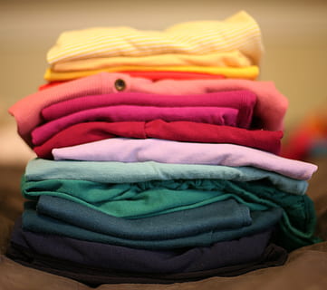 assorted-color top lot, folded, laundry, stack, t-shirt, red, clothes, clothing, indoors, multi colored, no people, close-up, choice, textile, variation, focus on foreground, towel, large group of objects, retail, store, fashion, heap, still life, group of objects, green color, clean, softness, warm clothing, turquoise colored, 2K, CC0, public domain, royalty free