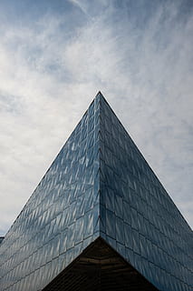 worm eye view photography, glass building, bottom, view, curtain, wall, building, blue, sky, architecture, infrastructure, clouds, triangle shape, modern, built structure, building exterior, futuristic, no people, outdoors, pyramid, low angle view, cloud - sky, city, office building exterior, office, nature, day, glass - material, shape, tall - high, pyramid shape, skyscraper, 4K, CC0, public domain, royalty free