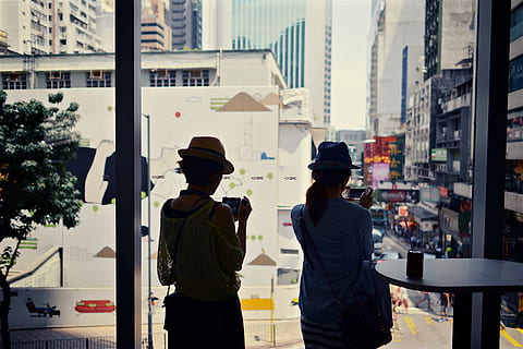 two, women, looking, window, Two women, looking through, through a window, Hong Kong, China, people, city, friends, woman, men, day, outdoors, two people, building exterior, rear view, built structure, city life, real people, architecture, hat, three quarter length, standing, clothing, lifestyles, togetherness, adult, casual clothing, leisure activity, uniform, 4K