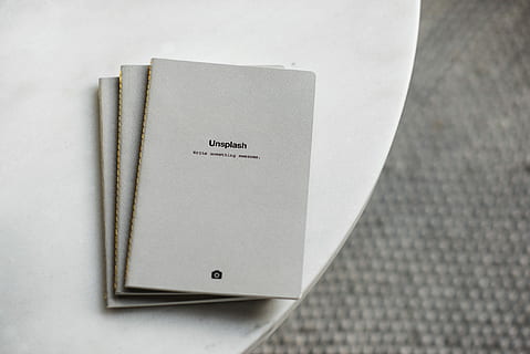 three, white, softbound books, surface, gray, books, table, notebook, notepad, grey, unsplash, table top, note, wooden, post, pattern, work, art, computer, nobody, binding, paper, close-up, no people, indoors, text, copy space, note pad, studio shot, document, high angle view, still life, book, reminder, publication, single object, simplicity, selective focus, communication, directly above, message, 2K, CC0, public domain, royalty free
