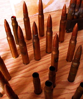 bullets, shells, ammunition, brass, cartridge, ammo, copper, shoot, gun, shooting, indoors, no people, high angle view, wood - material, close-up, table, still life, weapon, large group of objects, brown, side by side, arrangement, bullet, day, violence, choice, variation, abundance, art and craft, aggression, 2K, CC0, public domain, royalty free