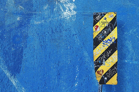 shot, blue, wall, sign, Closeup, blue wall, textures, text, no people, communication, water, day, western script, close-up, outdoors, guidance, high angle view, yellow, symbol, wall - building feature, direction, information, architecture, information sign, road, wood - material, 4K