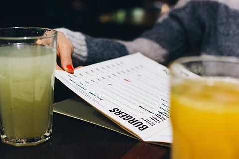 choosing, menu, bar, close up, hands, restaurant, drink, juice, drinking Glass, table, one Person, people, freshness, lifestyles, food, food and drink, one woman only, refreshment, glass, household equipment, midsection, close-up, human body part, indoors, adult, publication, holding, real people, hand, 5K