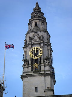 clock tower, tower, clock, time, famous, architecture, building, landmark, city, architecture design, structure, tourism, design, old, sky, built structure, low angle view, building exterior, flag, no people, travel destinations, blue, day, nature, sculpture, the past, history, belief, 2K, CC0, public domain, royalty free