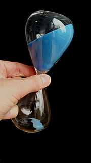 person, holding, hour glass, time conversion, egg timer, hourglass, clock, time, amount of time, hour, transience, timepiece, time difference, lag, temporal distance, period, range, duration, transient, tense, run out, sand, interval, silhouette, tempus, while, blue, hand, minutes, death, human hand, human body part, black background, drink, one person, refreshment, reflection, people, adults only, close-up, transparent, glass - material, body part, human finger, studio shot, finger, real people, indoors, food and drink, leisure activity, unrecognizable person, glass, 2K, CC0, public domain, royalty free