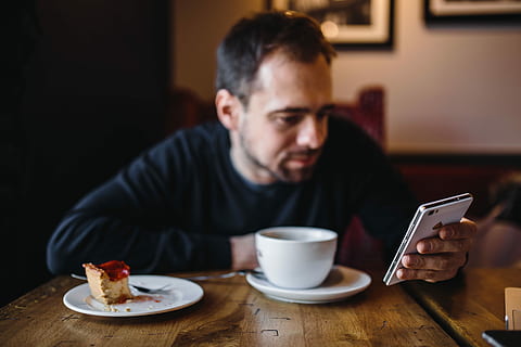 elegantly, dressed, man sititng, cafe, Young, man, caucasian, interior, coffee, break, male, city, business, indoor, indoors, men, people, coffee - Drink, one Person, males, adult, sitting, lifestyles, caucasian Ethnicity, table, technology, internet, wireless Technology, coffee Cup, one Man Only, casual Clothing, drink, cup, laptop, reading, only Men, communication, drinking, relaxation, digital tablet, food and drink, mug, connection, mobile phone, smart phone, portable information device, focus on foreground, crockery, 5K