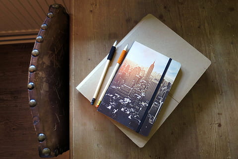 empire, state, building, binding, book, scripture, to write, note, notebook, notebooks, table, vintage, chair, work, signs, art, sketch, sketchbook, indoors, wood - material, no people, high angle view, directly above, studio shot, close-up, emotion, paper, still life, paintbrush, food and drink, choice, group of objects, social issues, brush, pattern, narcotic, 4K, CC0, public domain, royalty free