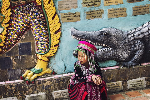 girl, wearing, multicolored, traditional, dress, sitting, wall, painted, taken, daytime, Child exploitation, Thailand, cultures, asia, women, people, architecture, india, indigenous Culture, children only, childhood, child, day, outdoors, real people, lifestyles, one person, clothing, leisure activity, art and craft, representation, built structure, creativity, front view, wall - building feature, adult, casual clothing, warm clothing, 5K, CC0, public domain, royalty free