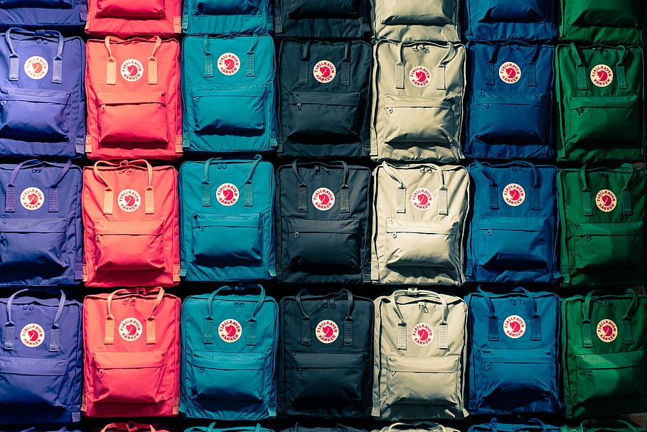 persona, mostrando, borse a colori assortiti, sacco per lo zaino a colori assortiti, zaino, simmetria, geometrico, modello, Borsa, Ingranaggio, negozio, memorizzare, Prodotto, colore, ripetere, uniforme, attrezzi all'aperto, capi di abbigliamento, tessuto, piazza, griglia, ripetizione, nessuno, multicolore, sfondi, fotogramma intero, di fila, scelta, fianco a fianco, variazione, grande gruppo di oggetti, pila, ordine, giorno, abbondanza, plastica, all'aperto, contenitore, preparativi, blu, avvicinamento, 4K