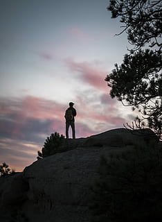 man, standing, mountain, trees, top, gray, boulder, portrait, backpack, silhouette, pink, blue, tree, hiking, rock, back, shiloette, sky, real people, rock - object, solid, beauty in nature, lifestyles, sunset, cloud - sky, men, leisure activity, one person, nature, scenics - nature, tranquility, tranquil scene, full length, outdoors, 4K, CC0, public domain, royalty free