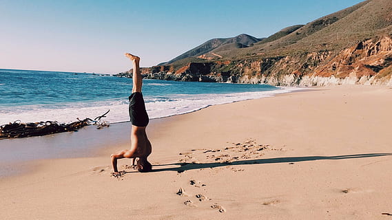 man, standing, head, seashore, balancing, upside, sea, shore, daytime, handstand, guy, beach, sand, footprints, ocean, water, mountains, hills, people, sunshine, sunny, summer, swim trunks, fitness, yoga, health, limb, human arm, arms raised, human body part, one person, flexibility, adult, sky, land, healthy lifestyle, lifestyles, nature, beauty in nature, day, full length, mountain, exercising, human limb, 1080P, CC0, public domain, royalty free