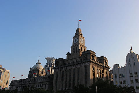shanghai, clock, clock tower, china, building, tower, city, chinese, travel, asia, old, architecture, urban, bund, light, sky, landmark, cityscape, oriental, structure, east, historical, downtown, famous, culture, flag, building exterior, built structure, nature, history, clear sky, the past, travel destinations, low angle view, day, no people, government, outdoors, spire, 5K, CC0, public domain, royalty free