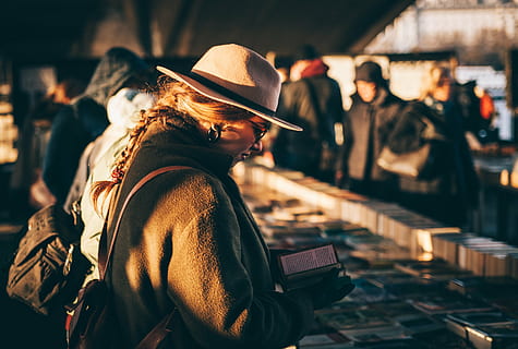 woman holding book, selective, photography, woman, reading, book, people, store, knowledge, men, hat, blur, only men, adult, adults only, working, industry, headwear, metal industry, protective workwear, clothing, focus on foreground, real people, incidental people, waist up, architecture, standing, city, side view, casual clothing, looking, concentration, lifestyles, business, 5K, CC0, public domain, royalty free