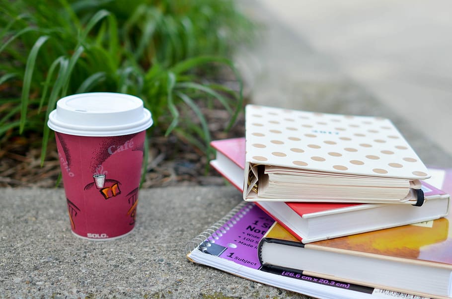 red, white, cup, beside, book, disposable, books, notebook, coffee, coffee cup, planner, paper cup, ground, floor, concrete, grass, cafe, spiral, organized, education, student, no people, day, focus on foreground, close-up, container, nature, stack, still life, outdoors, plant, group of objects, table, communication, publication, high angle view, food and drink, medium group of objects, 4K