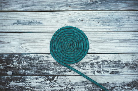 green, swirl rope photography, deck, rope, spiral, spool, coiled, blue, circle, pattern, full frame, no people, close-up, backgrounds, outdoors, day, architecture, wood - material, geometric shape, textured, shape, directly above, plank, table, wood, high angle view, design, nature, rough, 4K, CC0, public domain, royalty free