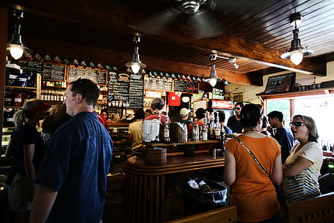 group, people, cafe, bar, caffe, coffee, shop, coffee shop, man, woman, order, signs, menus, bar - drink establishment, bar counter, happy hour, food and drink, restaurant, nightlife, pub, indoors, men, standing, group of people, adult, real people, women, business, lifestyles, leisure activity, crowd, rear view, small business, lighting equipment, 4K