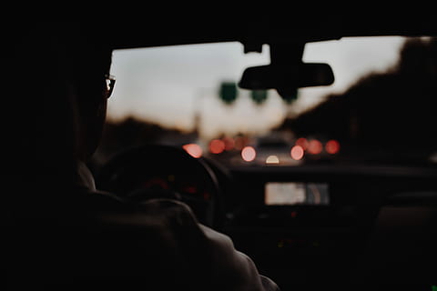 person driving car, man, sitting, inside, car, night, driver, windscreen, traffic, light, mirror, sunset, sunrise, highway, drive, mode of transportation, transportation, vehicle interior, motor vehicle, driving, car interior, windshield, travel, indoors, city, one person, illuminated, on the move, motion, glass - material, steering wheel, hand, control panel, dark, 5K, CC0, public domain, royalty free