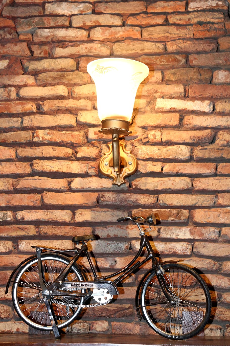 cykel, design, kreativitet, murstens væg, lampe, murbygningsfunktion, væg, belysningsudstyr, mursten, transportmidler, land køretøj, ingen mennesker, transportform, arkitektur, belyst, bygget struktur, elektrisk lampe, bygning udvendig, dag, stationær, gade, udendørs, lav vinkel visning, 2K