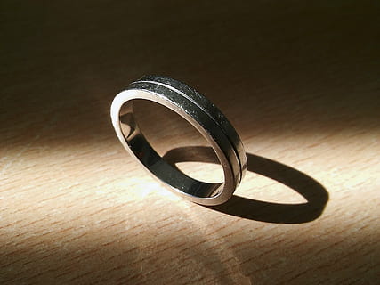 ring, sun, shadow, light, beam, jewelry, close-up, table, no people, indoors, still life, single object, metal, wood - material, high angle view, circle, sunlight, wedding ring, shape, geometric shape, personal accessory, engagement ring, design, silver colored, 2K, CC0, public domain, royalty free