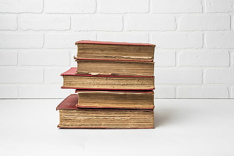 stacked red books, several, red, hard, bind books, white, surface, stack, wall, table, old, vintage, publication, book, wall - building feature, large group of objects, indoors, still life, brick, no people, hardcover book, education, brick wall, white color, built structure, architecture, white background, studio shot, expertise, 5K, CC0, public domain, royalty free