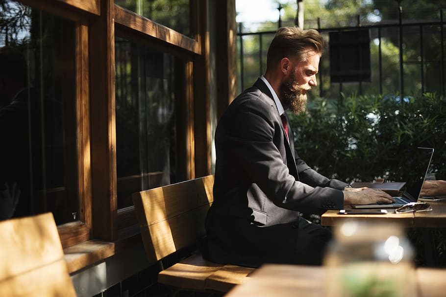 man, working, laptop, outside, shallow, focus photography, using, computer, cafe, beard, suit, work, outdoor, technology, business, wireless technology, table, one person, communication, males, men, sitting, using laptop, young adult, business person, smiling, businessman, office, young men, 5K